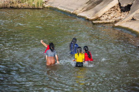 Asian young happy women bathing  in the river. Jumping and playing in the water. Chiang Mai, Thailand - November 12 2017.のeditorial素材