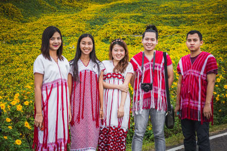 Locals wearing traditional clothes come to see sunflowers bloom at Doi Inthanon park. Chiang Mai, Thailand - November 11 2017.のeditorial素材
