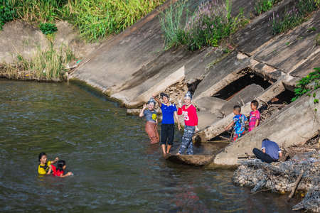 Asian young happy women bathing  in the river. Jumping and playing in the water. Chiang Mai, Thailand - November 12 2017.のeditorial素材
