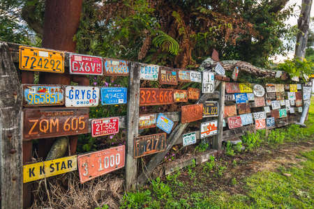 House and fence decorated with old car plates at Ross, New Zealand. Ross, New Zealand - January 01 2018.のeditorial素材