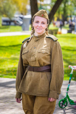 Woman dressed in old Soviet uniform at the celebration of the 75th anniversary of the victory in the Great Patriotic War, parade of May 9 in Minsk, Belarus. Minsk, Belarus - May 9 2020.のeditorial素材