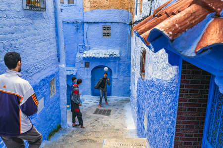 Boys play outside at the famous blue city of Chefchaouen, Morocco. Chefchaouen, Morocco - April 11 2016.のeditorial素材