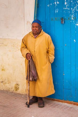 Man wearing traditional kaftan at the streets of Essaouira, Morocco. Essaouira, Morocco - April 14 2016.のeditorial素材