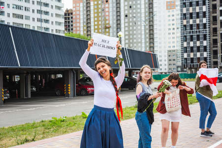 Woman holding sign in russian "no violence" during peaceful protests against stolen presidential elections in Minsk, Belarus. Minsk, Belarus - August 15 2020.のeditorial素材