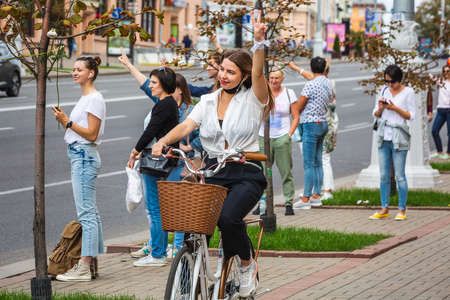 Woman holding flowers during peaceful protests against stolen presidential elections in Minsk, Belarus. Minsk, Belarus - August 15 2020.のeditorial素材