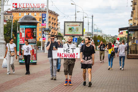 Man holding sign in russian "no violence" during peaceful protests against stolen presidential elections in Minsk, Belarus. Minsk, Belarus - August 15 2020.のeditorial素材