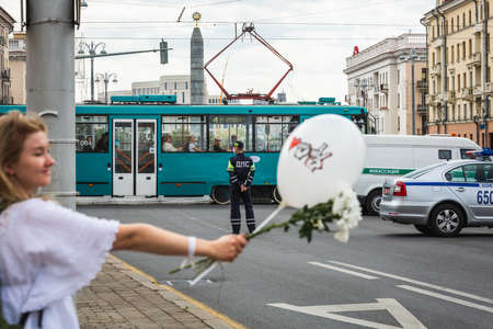 People holding flowers during peaceful protests against stolen presidential elections in Minsk, Belarus. Minsk, Belarus - August 15 2020.のeditorial素材