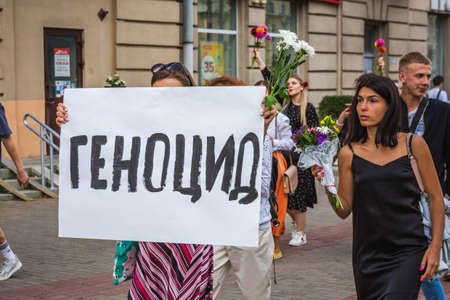 Woman holding sign in russian "genocide" during peaceful protests against stolen presidential elections in Minsk, Belarus. Minsk, Belarus - August 15 2020.のeditorial素材