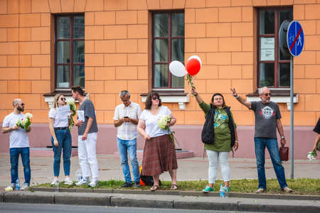 People holding flowers during peaceful protests against stolen presidential elections in Minsk, Belarus. Minsk, Belarus - August 15 2020.のeditorial素材