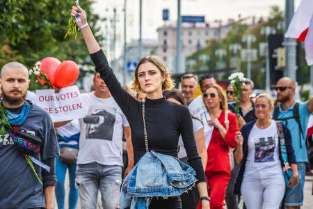 People holding flowers during peaceful protests against stolen presidential elections in Minsk,...