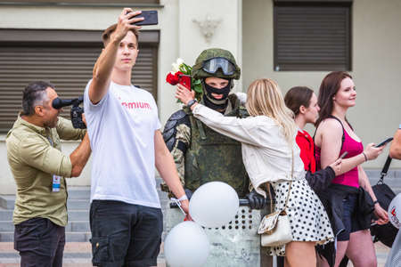 People hugging, crying and gifting flowers to soldiers at the main Independence Square near...