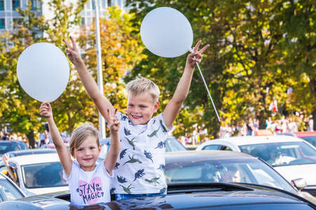 Young children during the biggest peaceful protests in Belarus history against rigged presidential elections in Minsk, Belarus. Minsk, Belarus - August 16 2020.のeditorial素材
