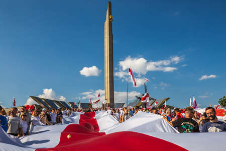Huge flag during biggest peaceful protests in Belarus history against rigged presidential elections in Minsk, Belarus. Minsk, Belarus - August 16 2020.のeditorial素材