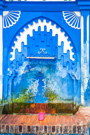 Typical moroccan narrow street in Chefchaouen. Blue city medina in Morocco with blue painted walls.