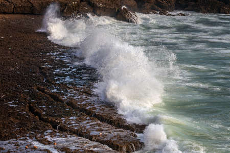 Waves breaking of cliffs near lagoon in Oualidia, Morocco.