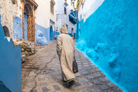 Typical moroccan narrow street in Chefchaouen. Blue city medina in Morocco with blue painted walls.