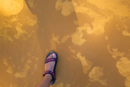 Trekker's foot at The Ocher Path le Sentier des Ocres through the Red Cliffs of Roussillon Les...