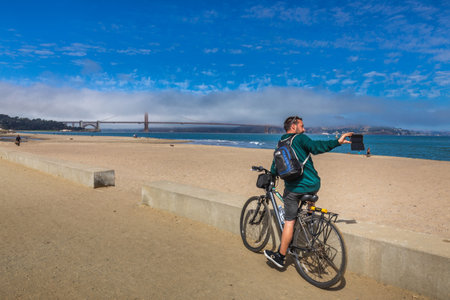 Travel in San Francisco, tourists enjoying the view of Golden Gate Bridge, San Francisco, California, USA. San Francisco, USA - September 14 2018.のeditorial素材