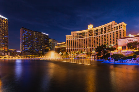 Fountains of Bellagio hotel with bright lights of hotels on Las Vegas Strip in Paradise, Nevada. Las Vegas, USA - September 28, 2018.のeditorial素材