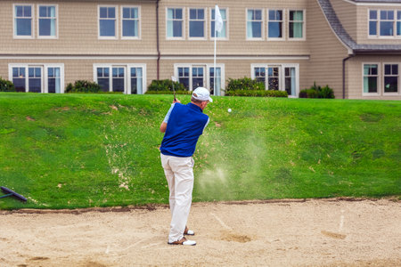 Golf player on a course hits balls by the pacific ocean bay. Half Moon Bay California. San Francisco, USA - September 15 2018.のeditorial素材