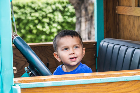 Young boy behind the wheel of the old car at the local winery near Sonoma, USA. Sonoma, Usa - September 12 2018.のeditorial素材