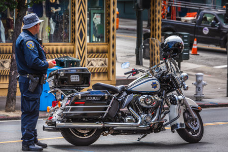 SFPD police officer and his motorcycle at patrol. San Francisco, USA - September 14 2018.のeditorial素材