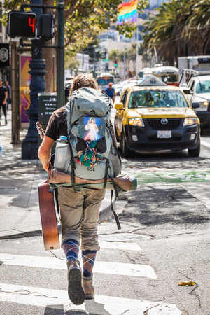 Hippie with a large bag on a streets of San Francisco. San Francisco, USA - September 14 2018.のeditorial素材