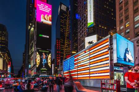 Times Square is a busy tourist intersection of neon art and commerce and is an iconic street of New York City and America. New York, USA - October 09 2018.のeditorial素材