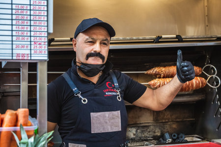Local Cook With Mustache Making Turkish Street Food Kokorec Made With Sheep Bowel. Istanbul, Turkey - September 30 2020.のeditorial素材