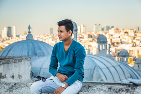 Man posing near The Suleymaniye Mosque. It is an Ottoman imperial mosque in Istanbul, Turkey. It is the largest mosque in the city. Istanbul, Turkey - October 01 2020.のeditorial素材