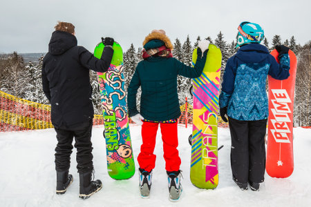 Friends riding on a snowboard in the winterのeditorial素材