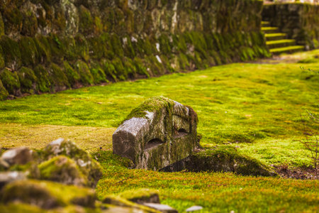 Moss-covered stone structure in a Japanese garden. Serene landscape with lush moss and ancient stonework. Tranquil and peaceful atmosphere. Perfect for meditation and relaxation.の写真素材