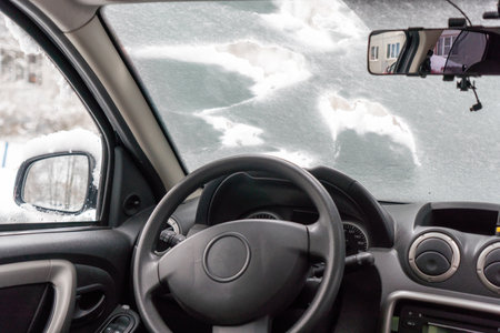 View from the driver's seat of the car in winter snowfall.の写真素材