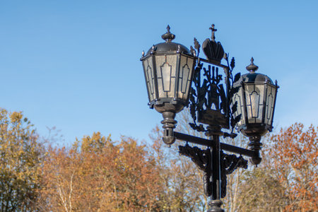 Vintage street lamp on a background of blue sky in the parkの写真素材