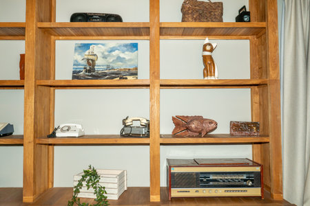 Wooden shelves with retro radio and other objects in the room.の写真素材