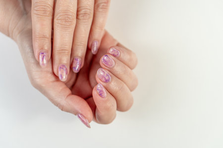 Female hands with pink nail design. beautiful female hands on white backgroundの写真素材
