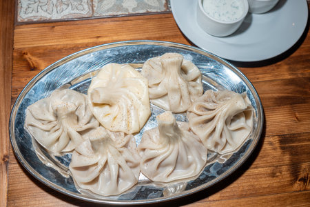 Georgian dumplings khinkali on a plate on a wooden tableの写真素材