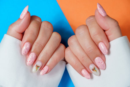 Female hands with pink nail design. Woman hands with pink manicure.の写真素材