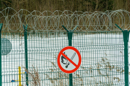 The sign Explosive on the fence of an industrial facility. The ban on fire.