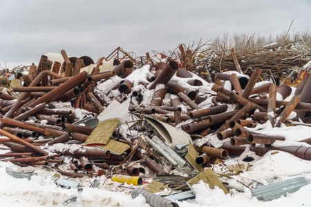 Pile of old rusty metal pipes in a scrapyard. industrial backgroundの写真素材