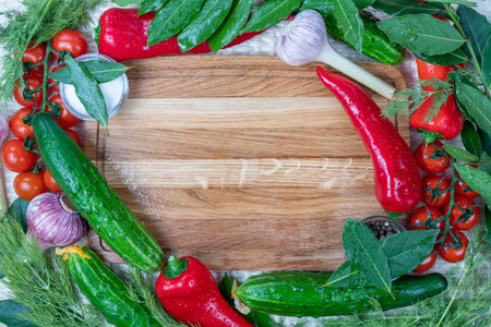 Frame of fresh vegetables and spices on wooden board. top view.の写真素材