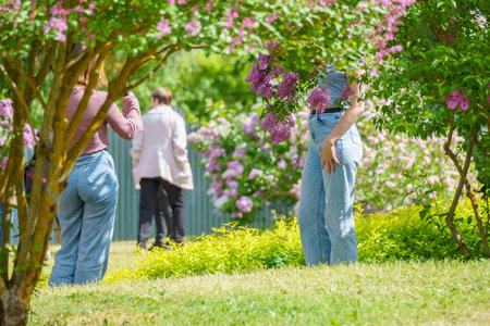 Woman with lilac flowers in the garden. lifestyle concept.の写真素材