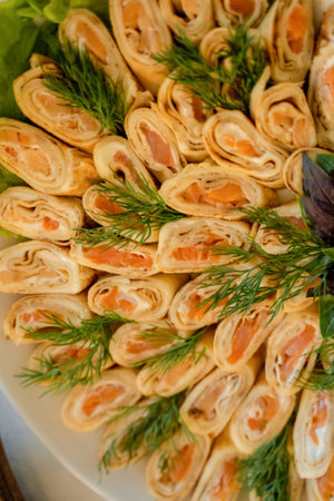 pancakes with salmon on a white platerated with dillの写真素材