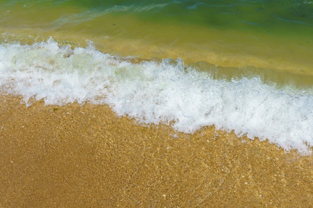 Soft wave of the sea on the sandy beach. Close up.の写真素材