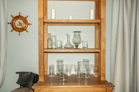 Shelves with different glassware in interior of room, stock photoの写真素材