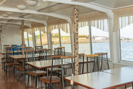 Wooden tables and chairs on a cruise ship in the open sea