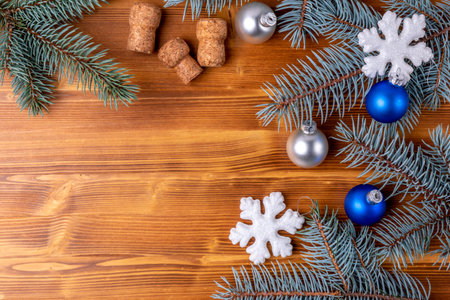 Christmas background with fir branches, blue balls and snowflakes on wooden boardの写真素材