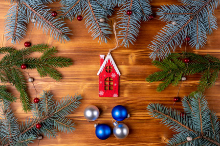 Christmas decoration with fir branches and blue balls on wooden background. Top viewの写真素材