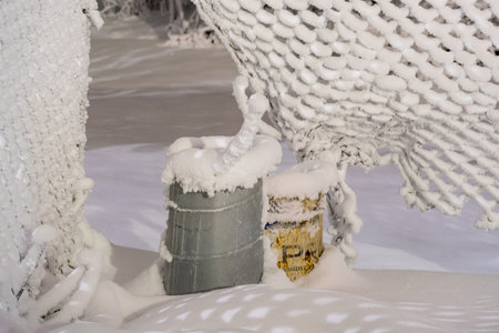 Snowy landscape with a hammock and a bucket in winter.の写真素材