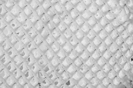 snow and frost on the metal fenceの写真素材